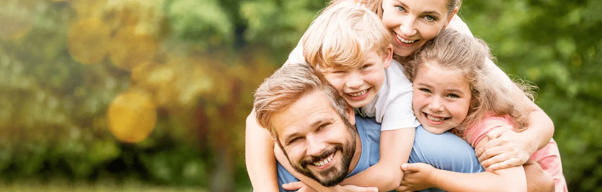A family embracing each other while all smiling.