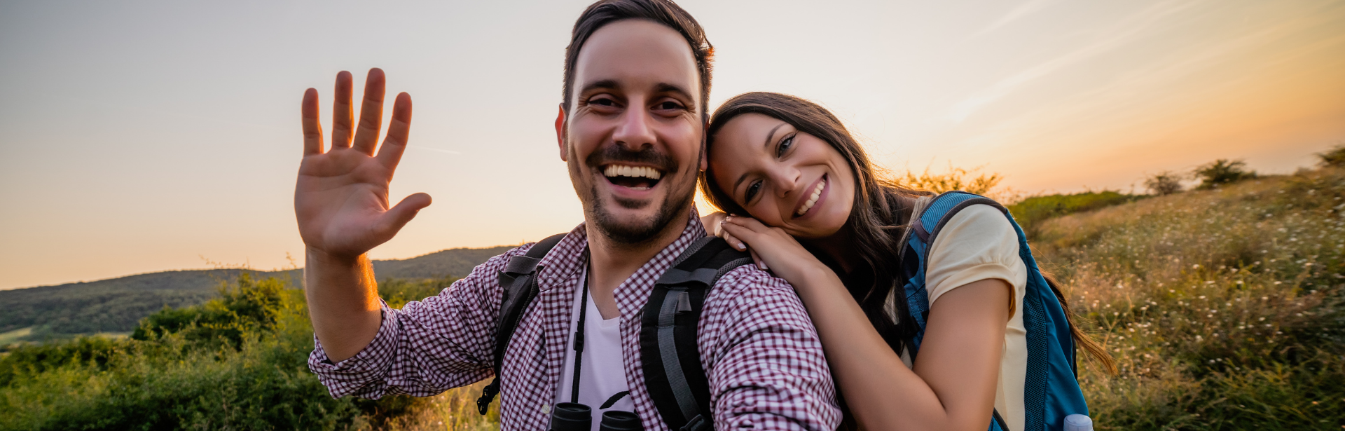 young couple smiling while hiking